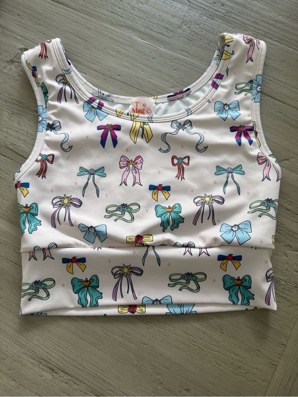 Shop the Magic Box Disney Princess Bow Print Cropped Sports Active Top